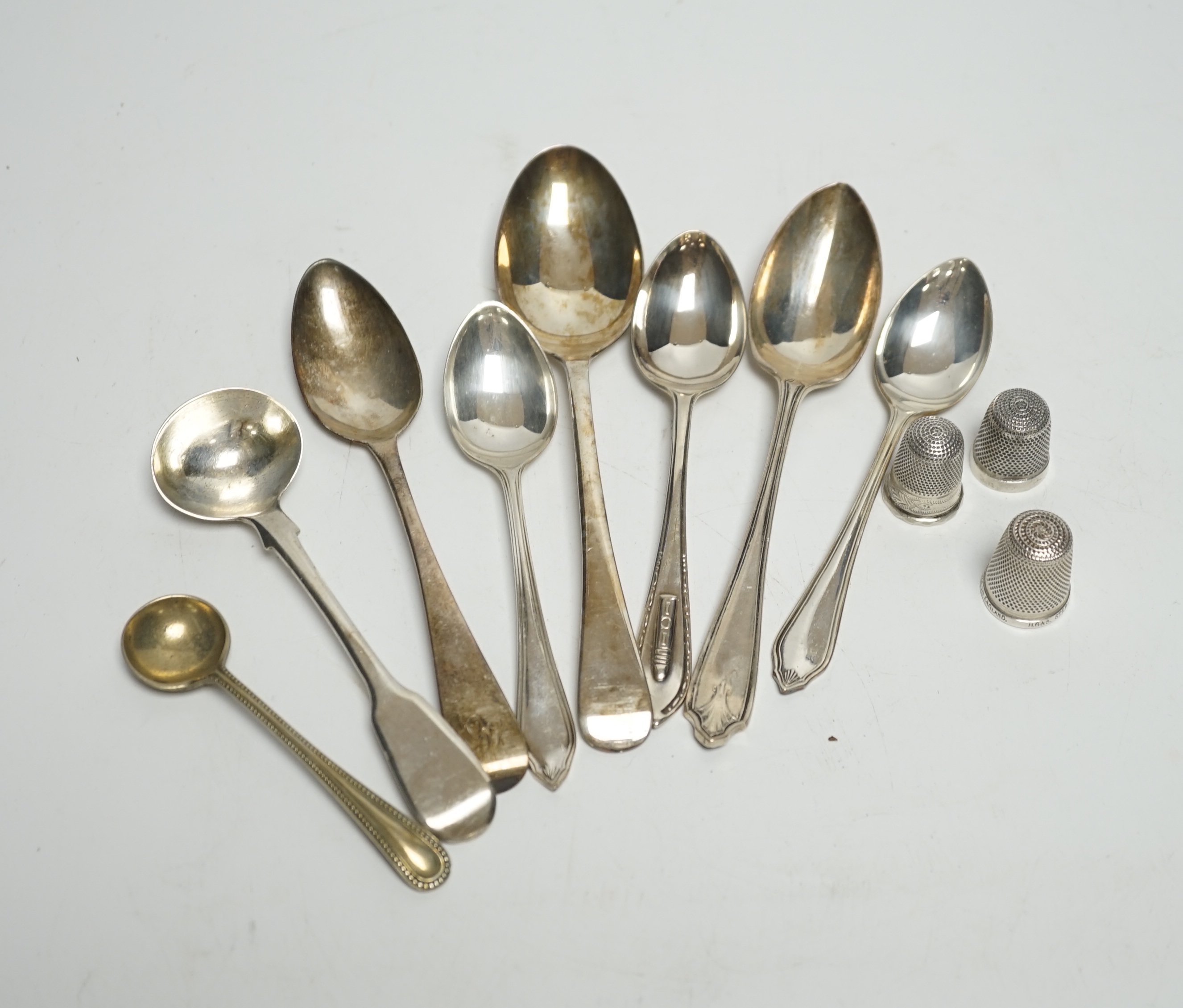 A small quantity of silver condiments and teaspoons, three silver thimbles and a sterling thimble.